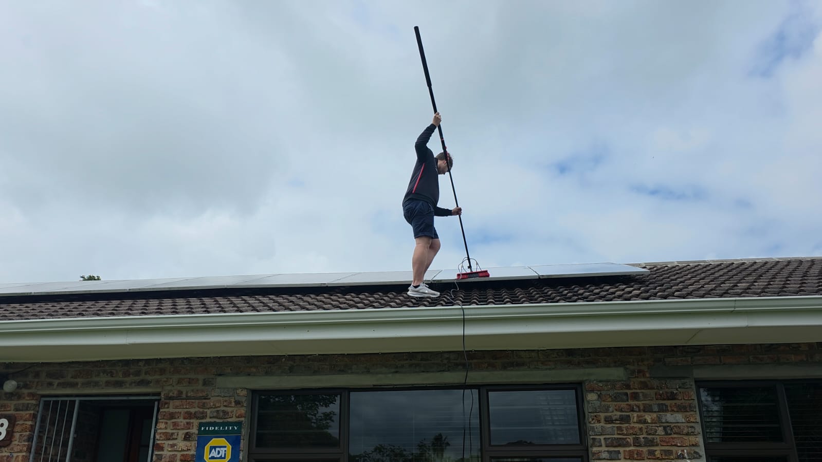 Sun Clean Solutions technician cleaning solar panels with a soft-bristle brush